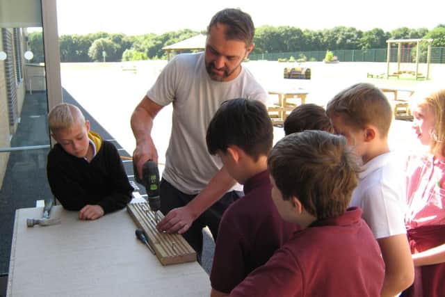 Boys find out from joiner David Clarke-Hippsley how to work with wood.