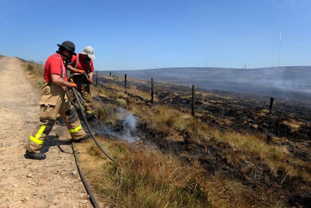 Firefighters from Lancashire and other forces have spent a week tackling a huge moorland fire on Winter Hill near Bolton, Lancashire, which was started deliberately. Picture: Paul Heyes.