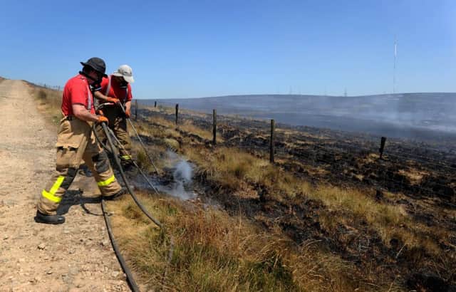 Firefighters from Lancashire and other forces have spent a week tackling a huge moorland fire on Winter Hill near Bolton, Lancashire, which was started deliberately. Picture: Paul Heyes.