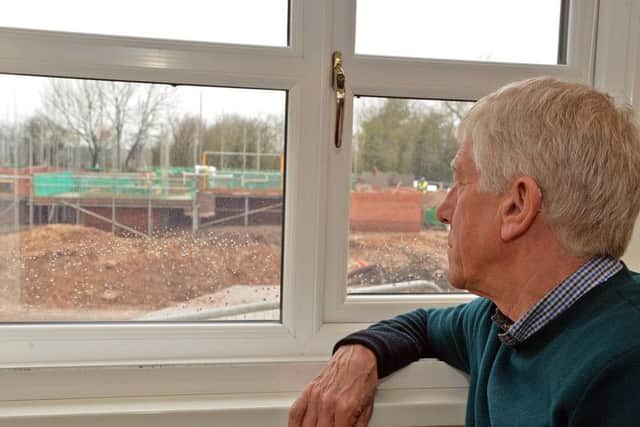 Mr Jordan looking out of the window before a fence was put up.