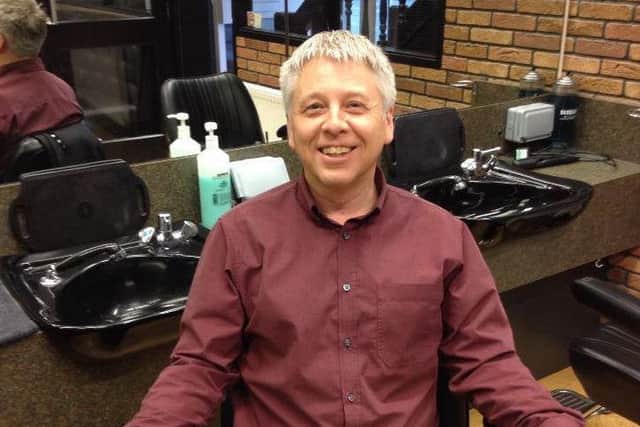 On his throne at the Campions salon -- owner Paul Sanderson.
