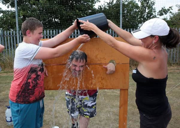 Winston White gets a cooling off from Gabe White and Jannine Bexon at Renfest, United Kingdom, 14th July 2018. Photo by Glenn Ashley.