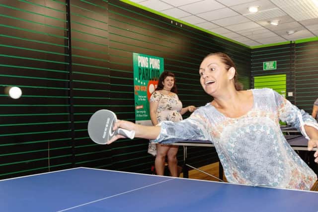 Shopper Lisa Bangert takes part in a vigorous game at Four Seasons brand new ping pong parlour
