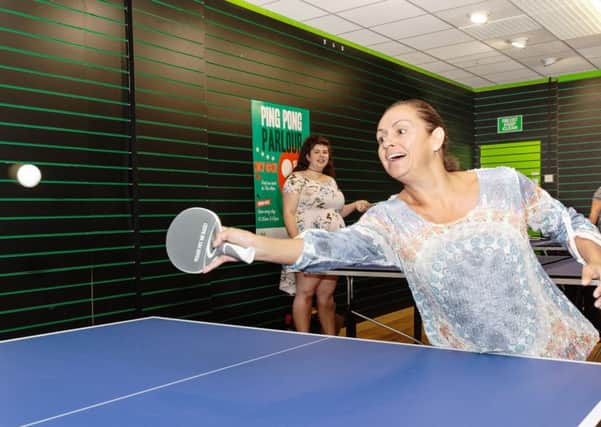 Shopper Lisa Bangert takes part in a vigorous game at Four Seasons brand new ping pong parlour