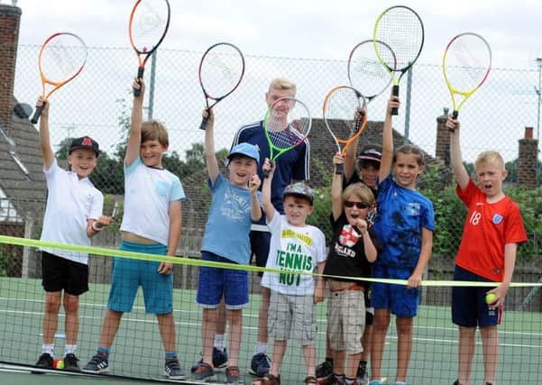 Mansfield Lawn Tennis Club free open day.   
Coach Euan Burgess with some of the youngsters who attended the open day session at the Mansfield Lawn Tennis Club on Saturday.