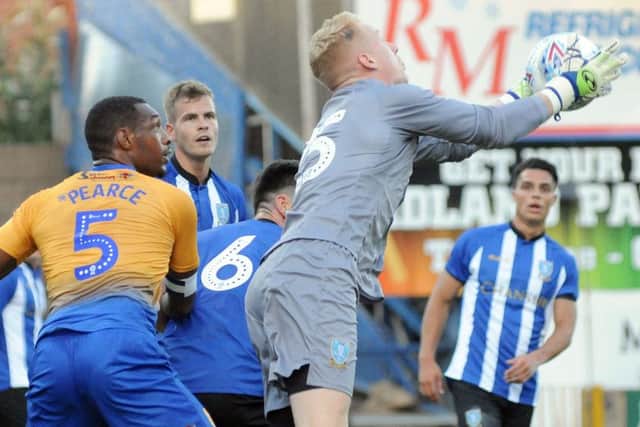 Mansfield Town v Sheffield Wednesday.Cameron Dawson claims the ball in the Wednesday penalty box.