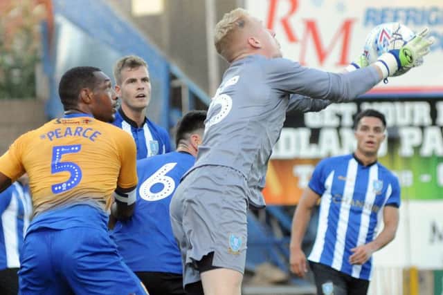 Mansfield Town v Sheffield Wednesday.
Cameron Dawson claims the ball in the Wednesday penalty box.
