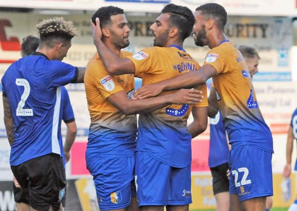 Mansfield Town v Sheffield Wednesday.
Mal Benning celebrates his first half goal with Jacob Mellis and CJ Hamilton.
