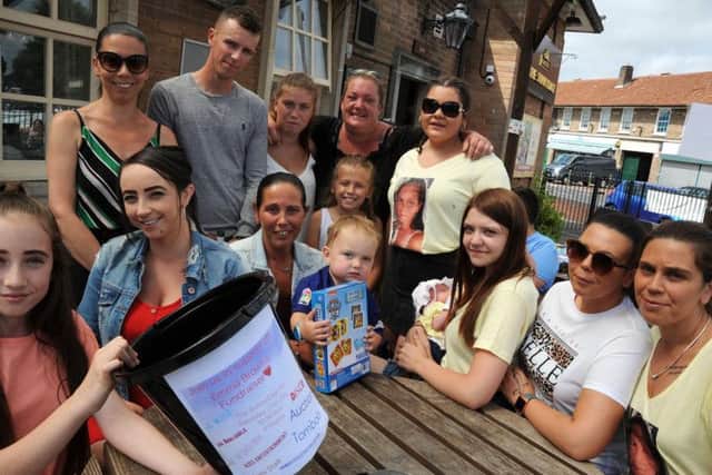 The family of Emma Brown gather together at the Sunnydale fundraiser with organiser Zoe Holmes on Saturday.