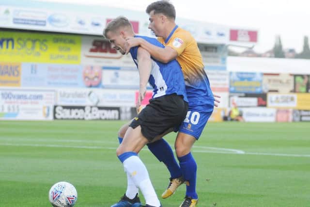 Mansfield Town v Sheffield Wednesday.Otis Khan is shielded from the ball by Yoost Van Aken.