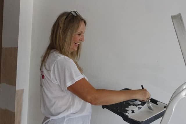 Volunteer Tracey Horton painting the new office.