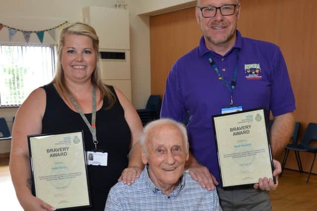 Cardiac arrest survivor Alan Moore is reunited with paramedics and bystanders who saved his life when he collapsed at a dance class, Alan is Pictured support worker Kelly Ashley and childrenâ¬"s Centre co-ordinator Mark Hoyland who performed CPR before the paramedics arrived