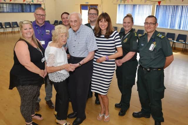 Cardiac arrest survivor Alan Moore is reunited with paramedics and bystanders who saved his life when he collapsed at a dance class, Alan is Pictured with his wife Pamela, daughter Joanne Waklin, support worker Kelly Ashley, childrenâ¬"s Centre co-ordinator Mark Hoyland who performed CPR before the paramedics arrived and paramedics