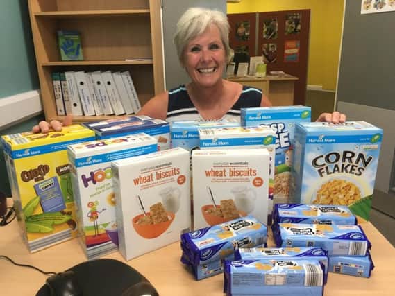 Yvonne Hudson, with her donation to the foodbank.