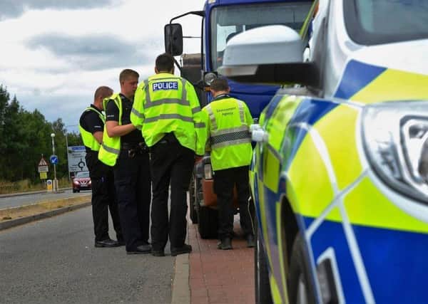 Pictured are Nottinghamshire police officers carrying out vehicle safety checks with ANPR number plate technology.