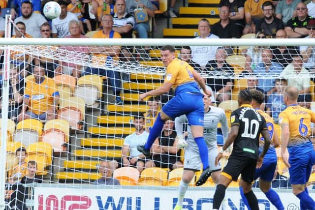 Mansfield Town v Newport County.
Matt Preston makes an aerial clearance in the first half.