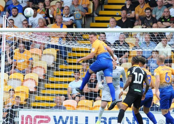 Mansfield Town v Newport County.
Matt Preston makes an aerial clearance in the first half.