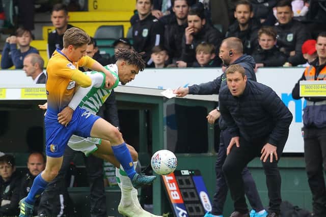Stags' Danny Rose battles with Yeovil's Omar Sowunmi as David Flitcroft urges him on in the fixture last season