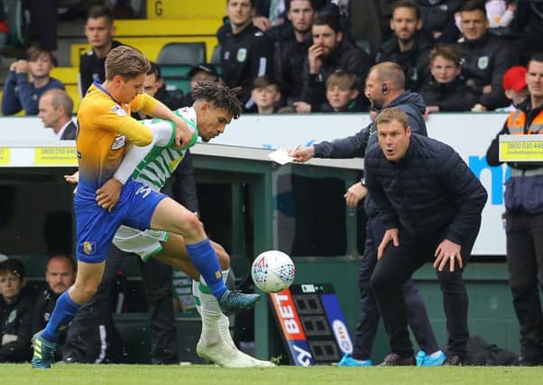 Stags' Danny Rose battles with Yeovil's Omar Sowunmi as David Flitcroft urges him on in the fixture last season