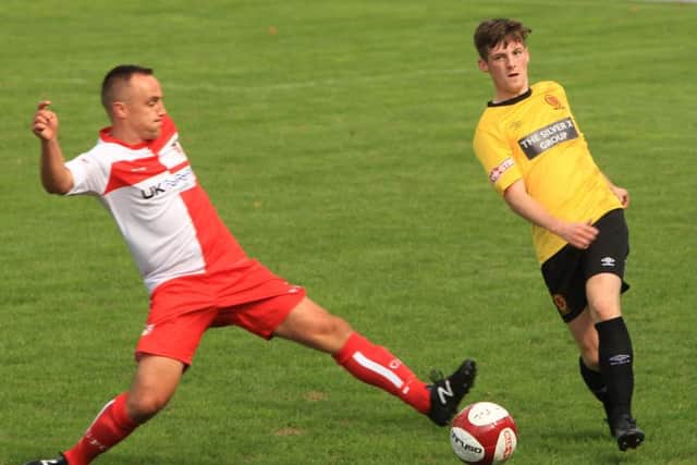 Gresleys Eric Graves challenges Belpers Cameron Clark for the ball. (PHOTO BY: Tim Harrison)