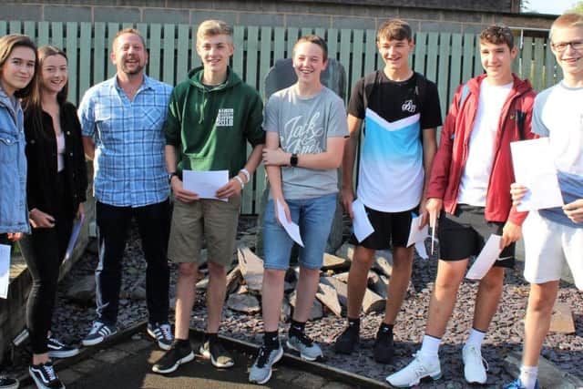 Students celebrate their exam results with maths teacher Mr Lyndon