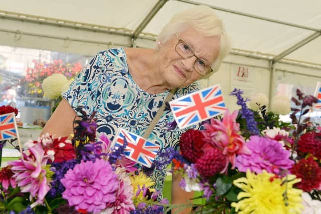 Mansfield garden and craft festival 2018. Jean Hodgson looking at the flower displays.