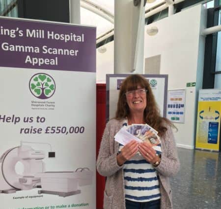 Resident Diane Bradbury celebrates winning £100 at the Gammer Scanner Appeal raffle.