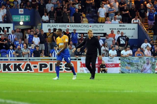 Mansfield Town v Sheffield Wednesday. Krystian Pearce is led away from trouble at the end of the game.