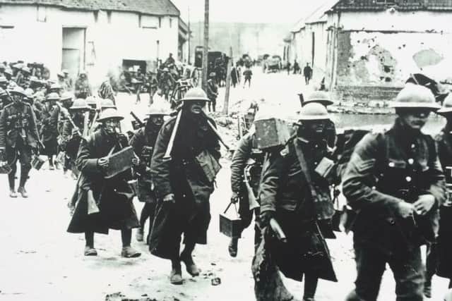 British soldiers marching through Bouzincourt during the First World War. Many soldiers holed uop in caves beneath Bouzincourt during the war and their etchings on the walls remain today
