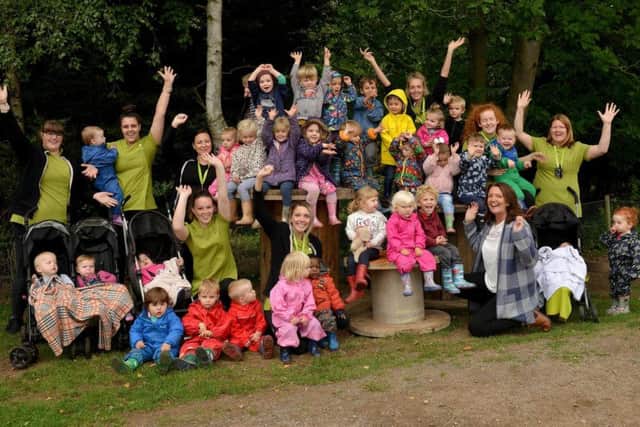 Owner Gina Smith is pictured celebrating with staff and children