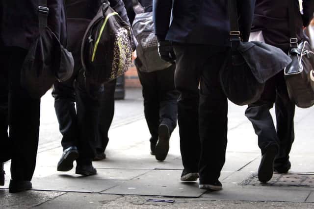 File photo dated 26/01/12 of school pupils. According to new figures arrests of children in England and Wales have fallen by more than two-thirds since the start of the decade.