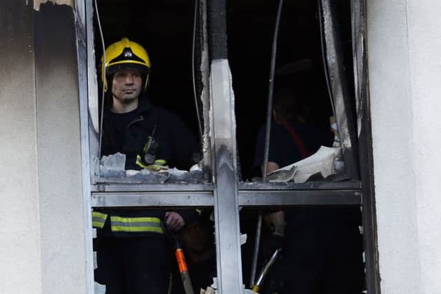 Firemen at Mennard House, Galway Street, Finsbury, London where a fire broke out in a third floor flat.