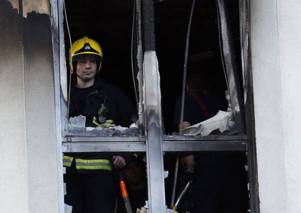 Firemen at Mennard House, Galway Street, Finsbury, London where a fire broke out in a third floor flat.