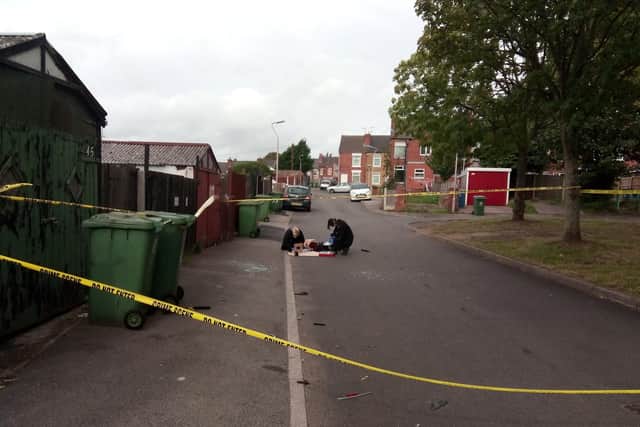A forensic team is at the scene.