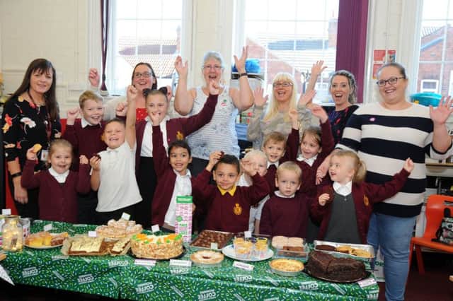 Cheers go up for the Macmillan coffee morning held at the King Edward Primary School on Friday.