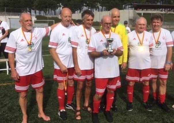 Mansfield Senior Reds in Spain with their trophy.