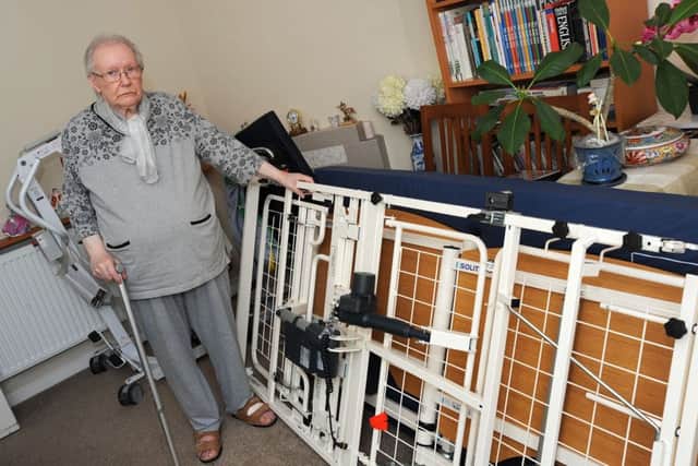 Jackie Wells with the equipment loaned to her husband by the Red Cross which has not been collected.