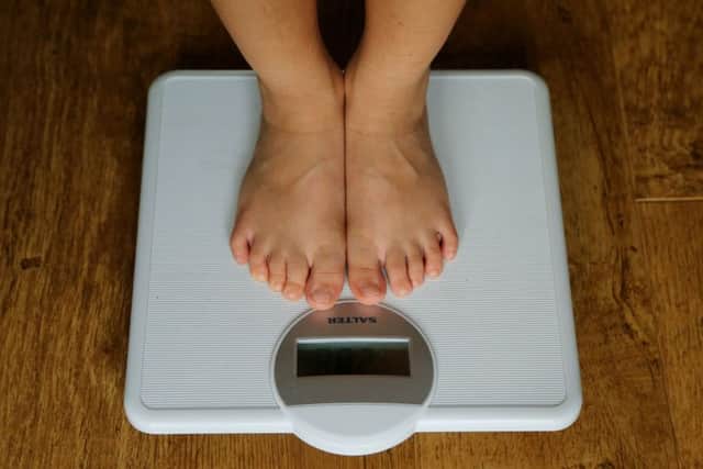 Embargoed to 2330 Wednesday July 04 File photo dated 15/07/14 of a child being weighed on scales. Children whose mums stay healthy while they grow up are &quot;substantially&quot; less likely to be obese, research suggests.