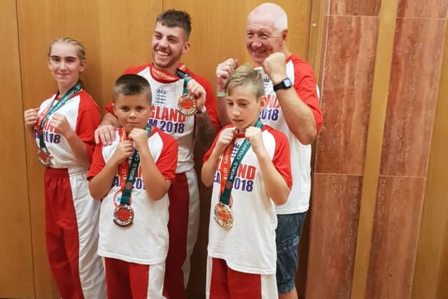 Students at the Genesis Kickboxing Academy, with their coach, who competed for Team England in Portugal.