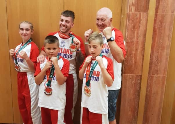 Students at the Genesis Kickboxing Academy, with their coach, who competed for Team England in Portugal.