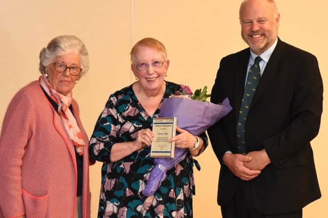 Volunteer Sonia Tate (centre) receives her award from Trust chairman John MacDonald and Barbara Joules, of the Mansfield and Sutton League of Friends.