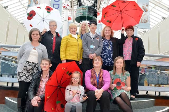 People involved in making the rememberella installation gather at Idlewells shopping centre in Sutton in Ashfield.