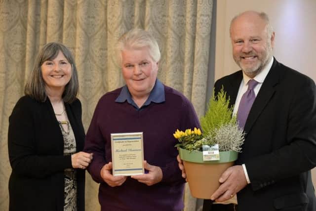 Volunteer Michael Shannon (centre), flanked by John MacDonald and Jill Smallwood, of the trust.