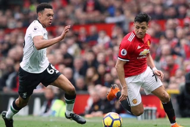 Liverpool's Trent Alexander-Arnold (left) and Manchester United's Alexis Sanchez battle for the ball.