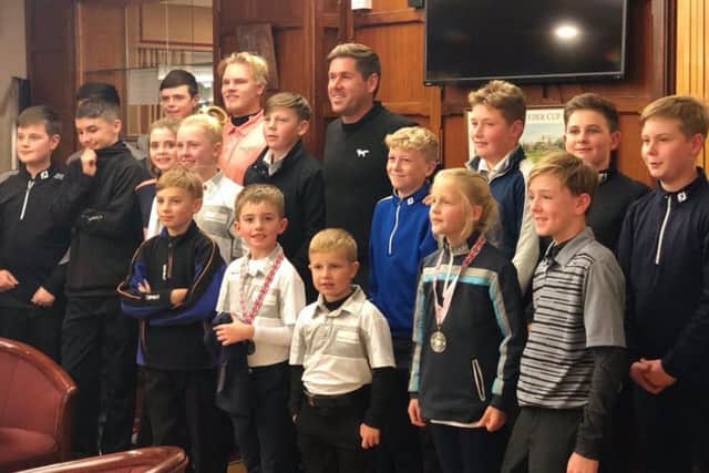 Albie (front row, centre) with other young golfers and Robert Rock.