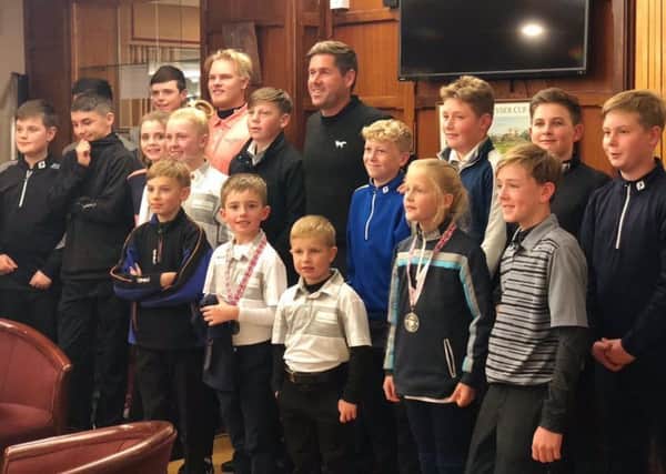 Albie (front row, centre) with other young golfers and Robert Rock.