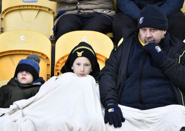 Mansfield Town fans try to keep warm during the game: Picture by Steve Flynn/AHPIX.com, Football: Skybet League 2  match Mansfield Town -V- MK Dons at One Call Stadium, Mansfield, Nottinghamshire, England on copyright picture Howard Roe 07973 739229