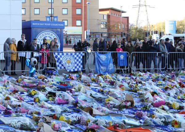 Flowers and tributes being left at the scene at the King Power Stadium in Leicester the morning after the helicopter crash.