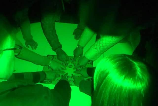 One of the teams try out the Ouija board