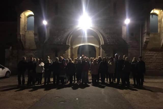 The paranormal investigators outside the courtyard